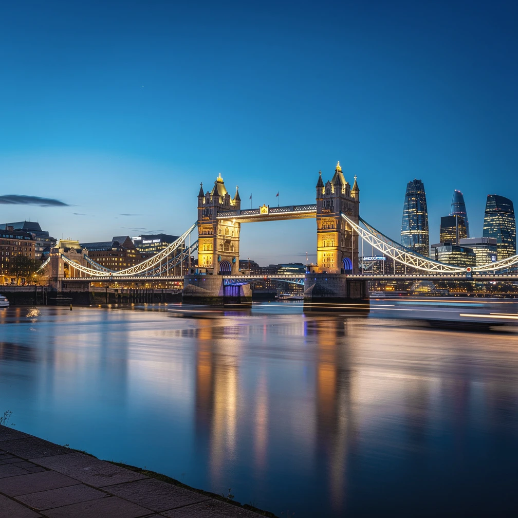 Tower Bridge London at blue hour with city skyline reflected in Thames